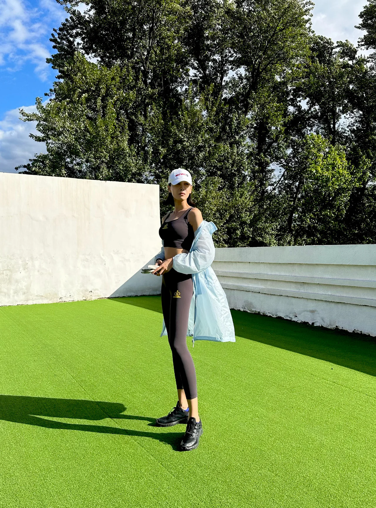 Athletic Chic: Black Sports Set with Light Blue Oversized Jacket and White Cap