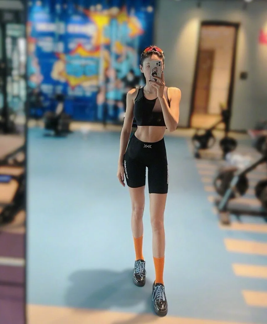 Sporty Black Crop Top and Biker Shorts with Bold Orange Socks