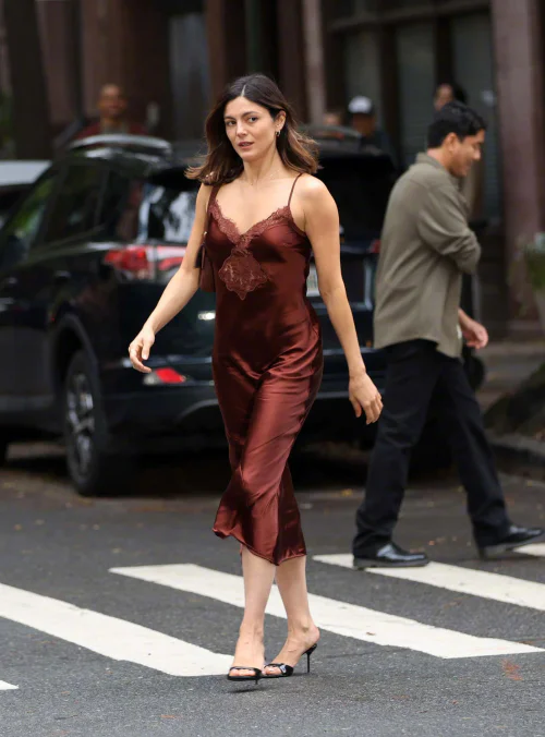 Stills from Monica Barbaro's new film. Elegant Deep Brown Satin Slip Dress with Lace Details and Strappy Heels