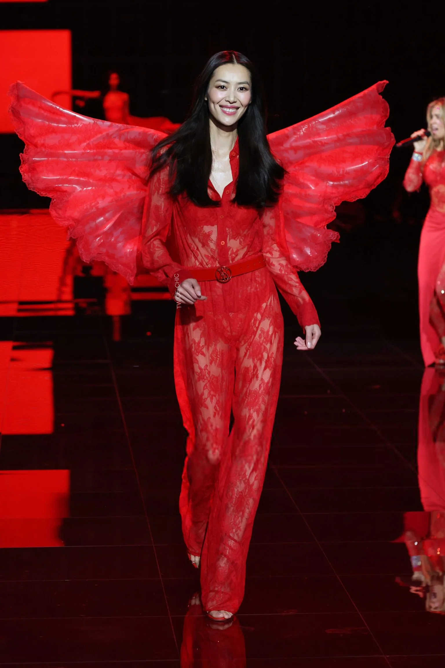 2025 Victoria's Secret Fashion Show. Vibrant Red Lace Ensemble with Dramatic Wings for a Show-Stopping Effect