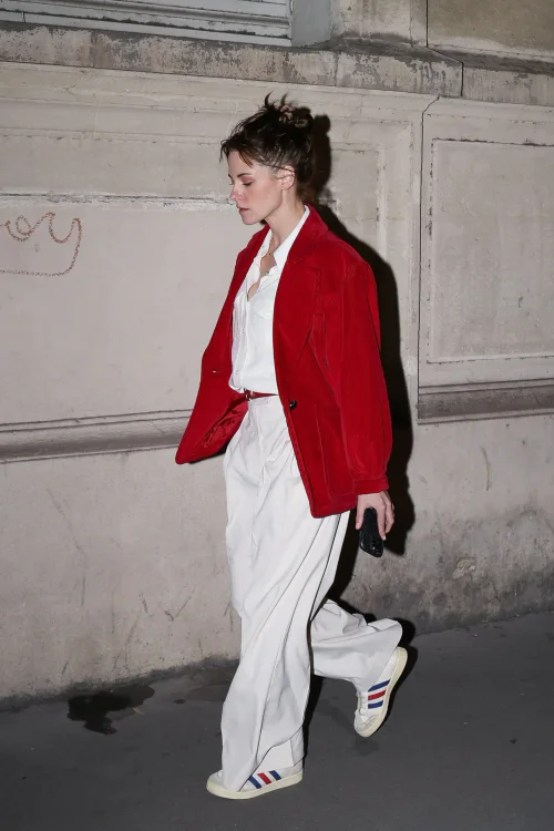 Kristen Stewart OOTD. Vibrant Red Jacket and White Ensemble with Sporty Accents