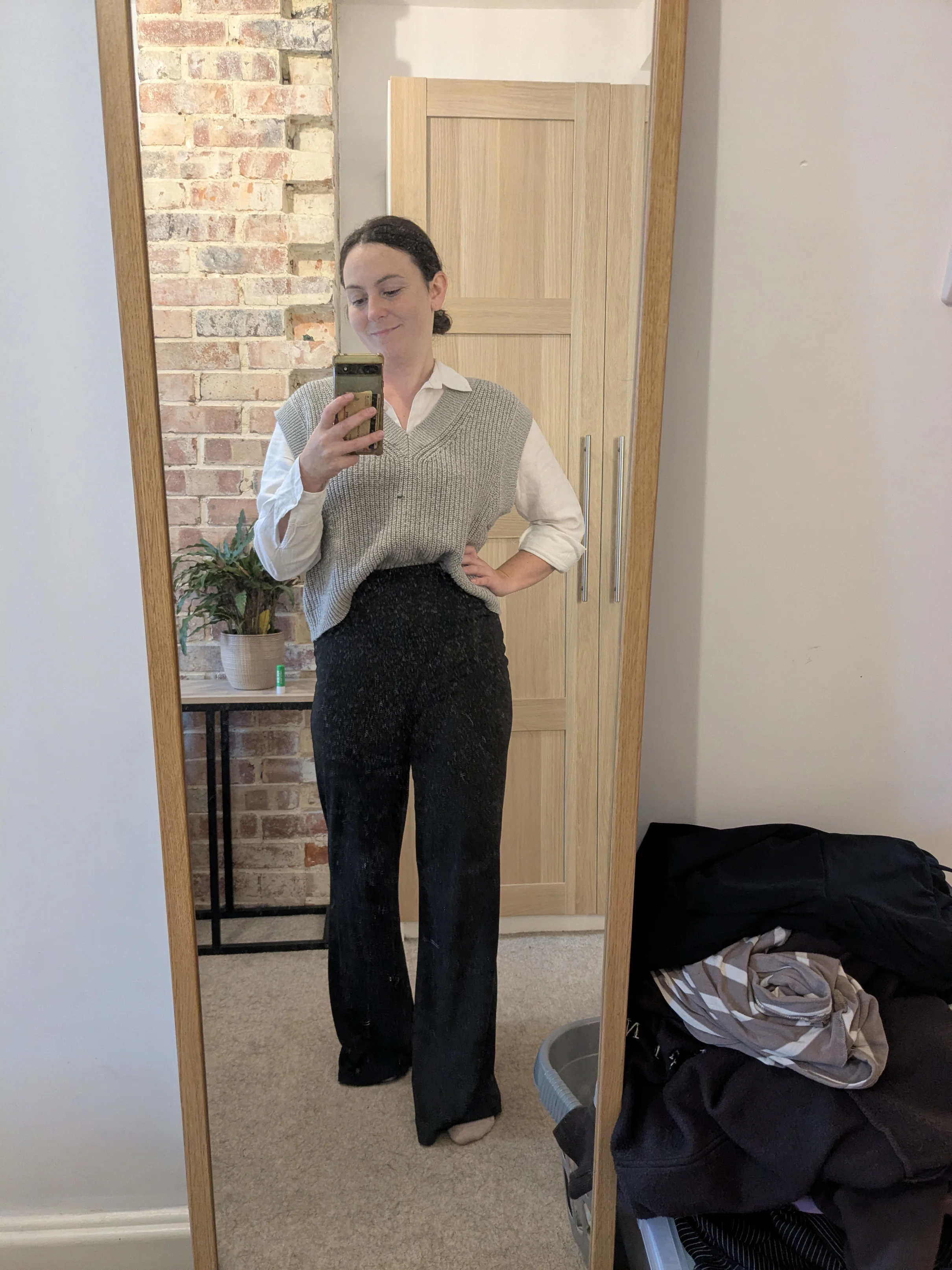 Monochrome Ensemble with Oversized Knit Vest and Trousers: A Retro Nod or Fashion Faux Pas?