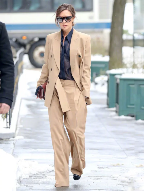 Victoria Beckham OOTD Rate. Sleek Tan Suit with Contrasting Dark Blouse for Polished Elegance