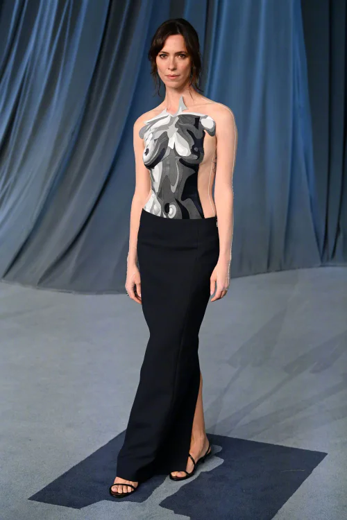 Rebecca Hall. Abstract Design Halter Dress with Sleek Black Skirt and Strappy Sandals