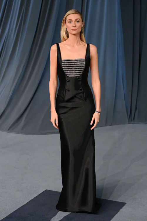 Elizabeth Debicki at Academy Museum Gala. Black Satin Gown with Silver Corset Details and Elegant Silhouette
