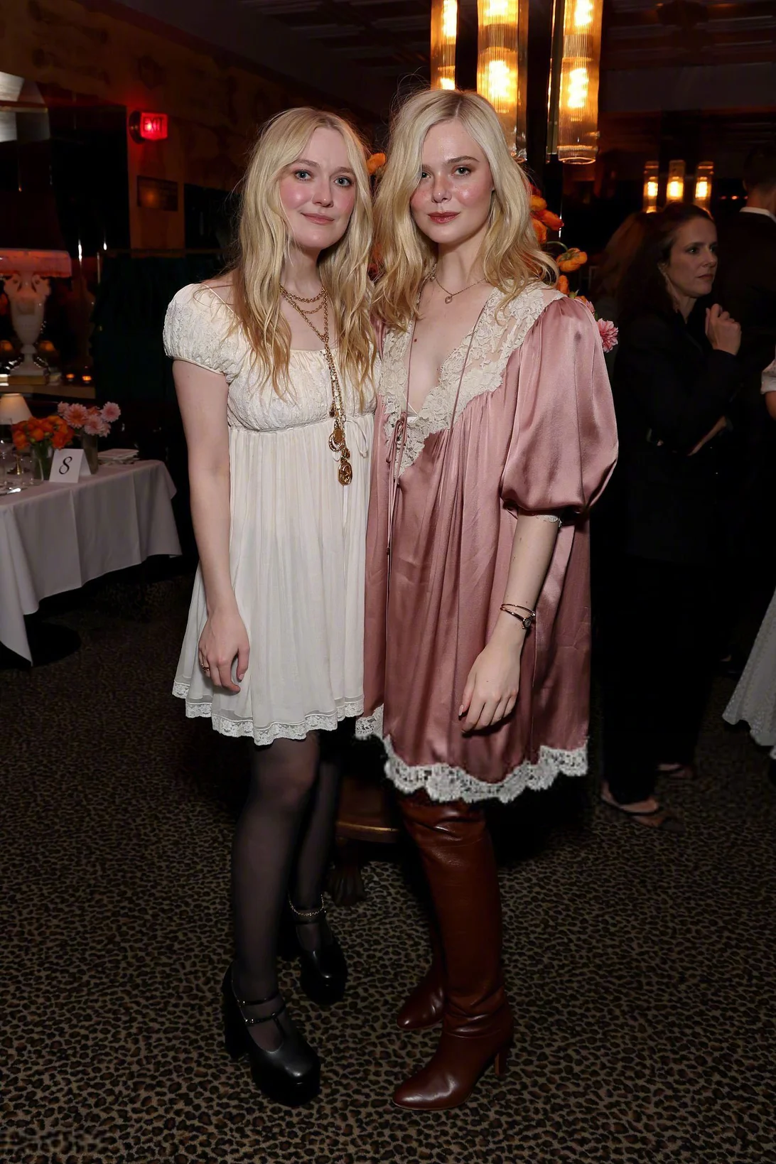 Fanning sisters' Outfit Ratings. Vintage Charm with Modern Accessories: Cream and Blush Dresses with Lace Accents