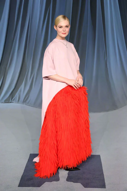 Elle Fanning in Balenciaga Spring/Summer 2026 Collection. Dramatic Pink and Red Ensemble with Feathered Train for a Bold Statement Look