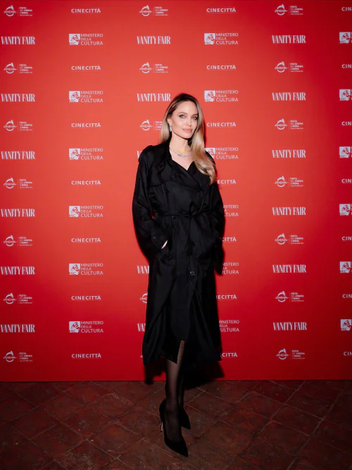 Angelina Jolie. Timeless Elegance in a Black Trench Coat and Monochrome Accessories
