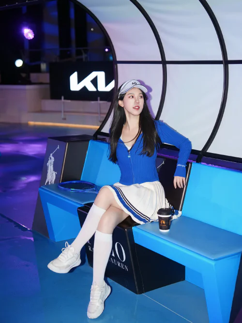 Sporty Chic: Blue Cardigan and White Skirt Combo with Sneakers