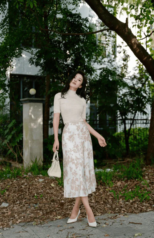 Elegant Beige Top with Floral Midi Skirt and White Accessories for a Chic Look