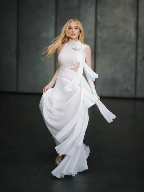 Lindsay Lohan in Elegant White Asymmetrical Dress with Flowing Fabric Details