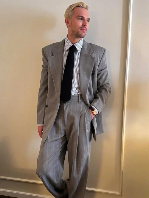 Nicholas Hoult in Vintage-Inspired Gray Suit with Striped Shirt and Black Tie: A Modern Take on Classic Menswear