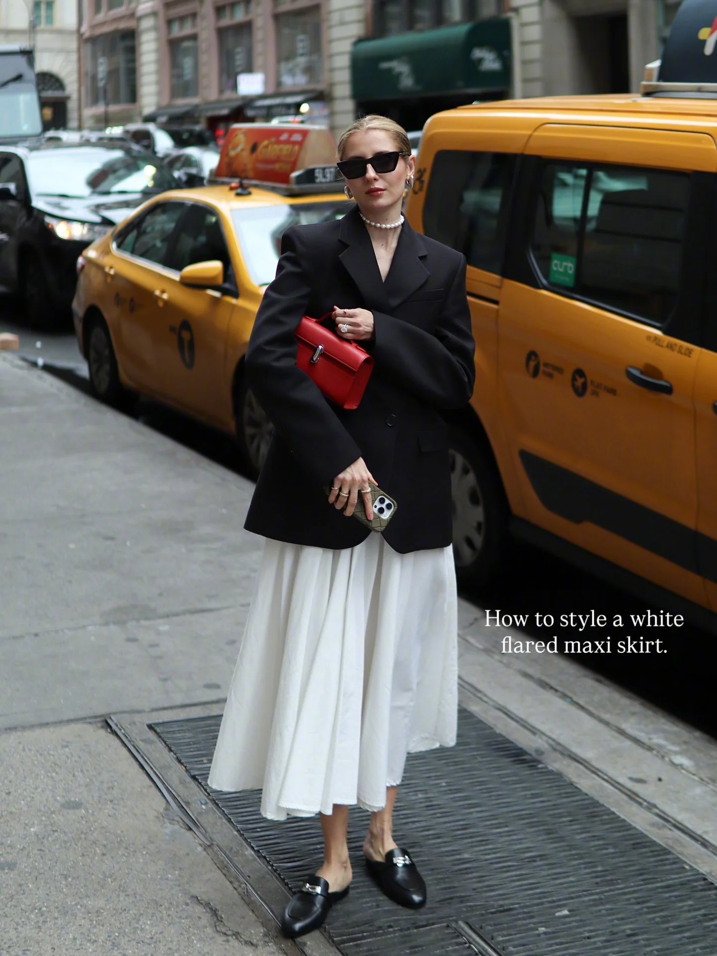 Sophisticated Minimalism: Black Blazer with White Maxi Skirt and Red Clutch
