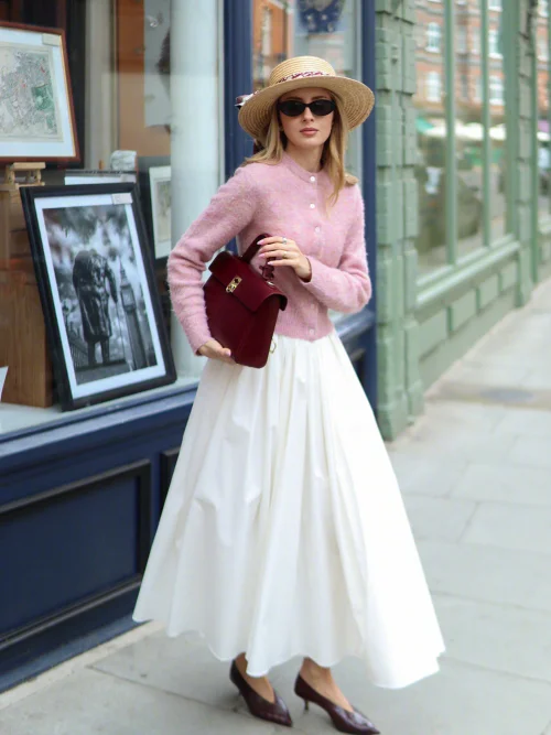 Elegant Vintage Charm in Pink Cardigan and White Skirt with Straw Hat