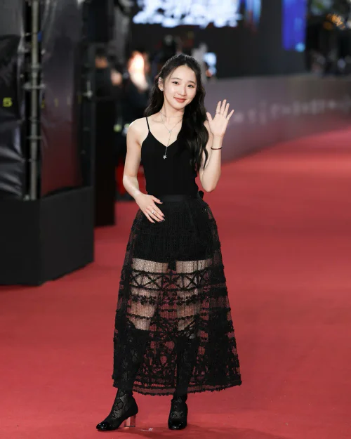 Classic Black Top and Intricate Lace Skirt with Heeled Boots on Red Carpet