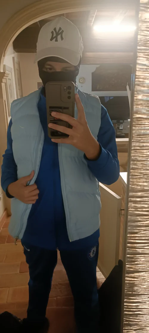 Sporty Blue Tracksuit with Light Blue Puffer Vest and White Cap