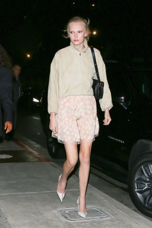 Chic Nighttime Street Style with Beige Pullover and Polka Dot Skirt 