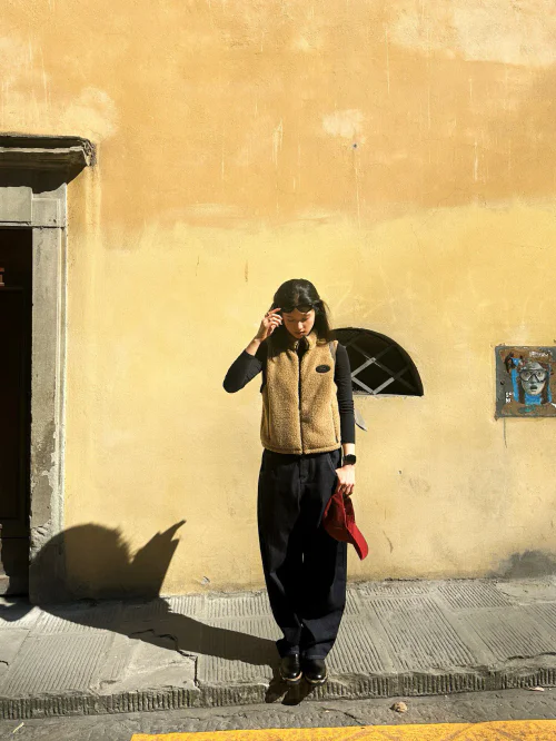 Cozy Tan Fleece Vest with Black Layers and a Pop of Red