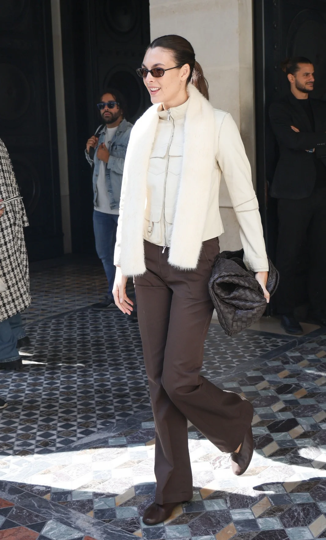 Vittoria Ceretti out in Paris. Chic Neutral Outfit with Cream Jacket and Brown Trousers for a Modern Classic Look