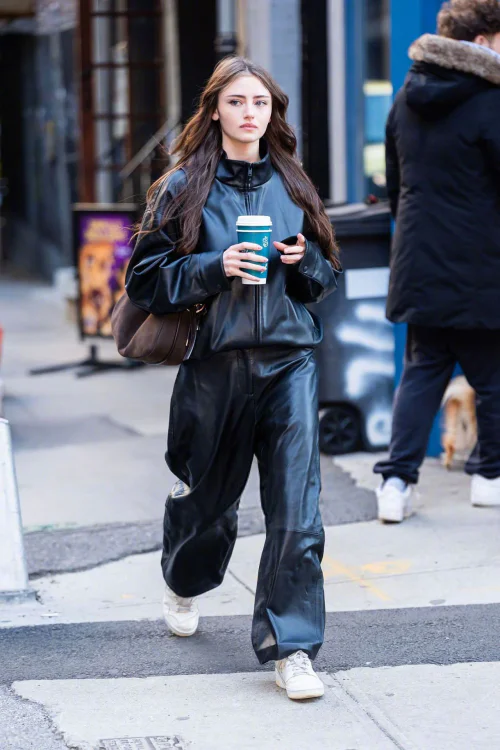 Leni Krum's New York Street Style. Edgy Black Leather Ensemble with White Sneakers and Brown Bag