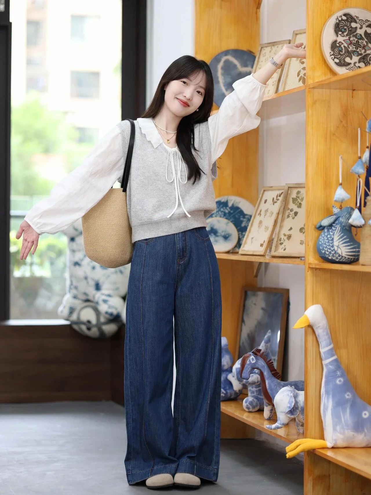Effortlessly Chic: Gray Sweater Vest with White Blouse and Wide-Leg Jeans