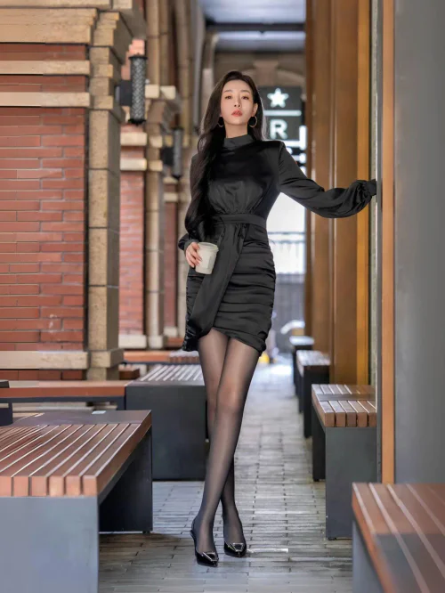 Elegant All-Black Satin Dress with Sheer Tights and Heels for a Sophisticated Look
