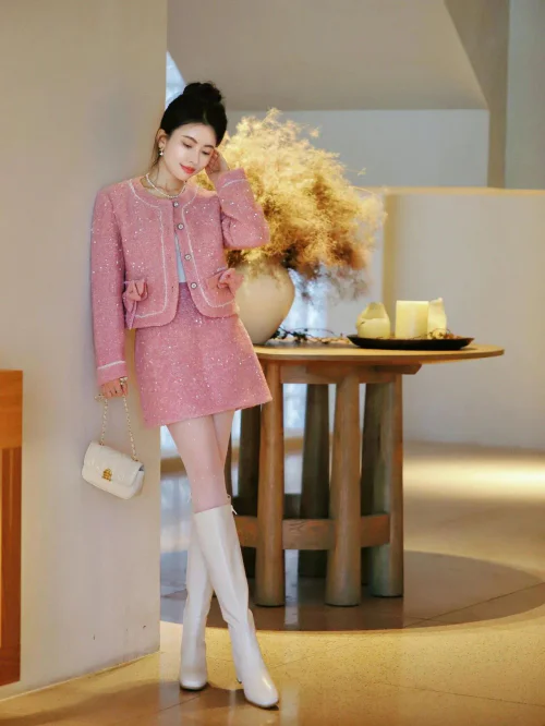 Chic Pink Tweed Skirt Suit with White Boots and Quilted Handbag