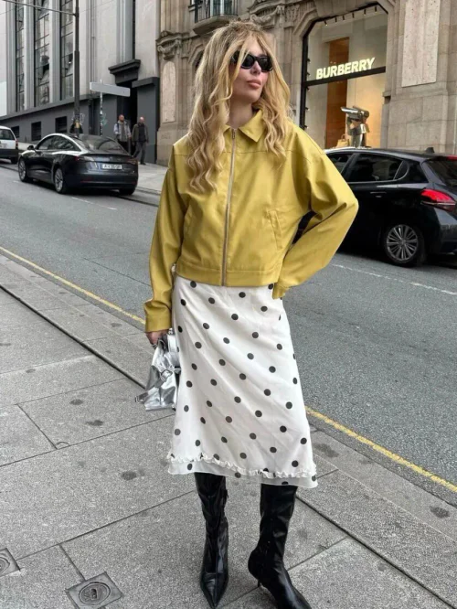 Chic Street Style: Mustard Jacket and Polka-Dot Skirt with Knee-High Boots