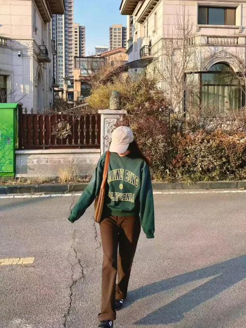 Casual Earth-Tone Style with Green Sweatshirt and Brown Flared Pants
