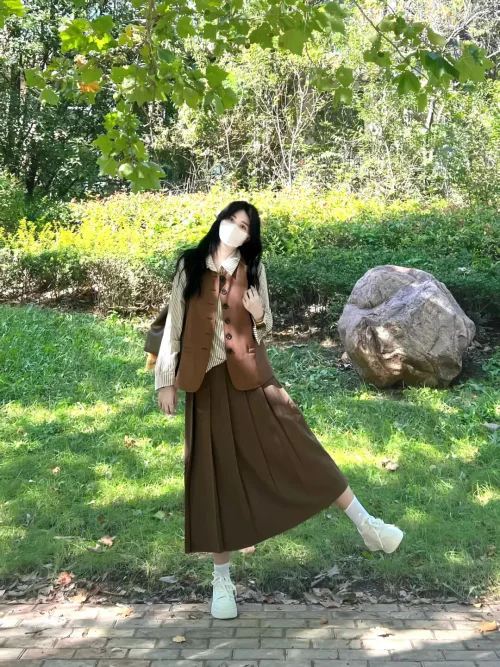 Elegant Autumn Style with Brown Pleats and Striped Shirt