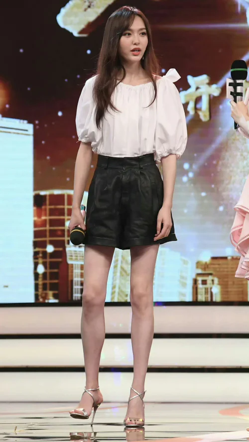 Chic Monochrome Ensemble with Voluminous Blouse and Leather Shorts