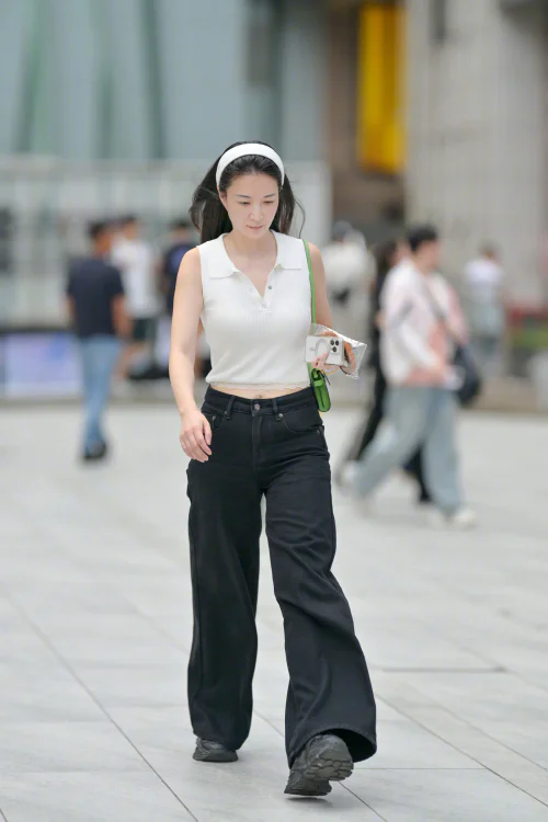 Classic Chic: White Polo Top and Black Wide-Leg Pants with a Pop of Green