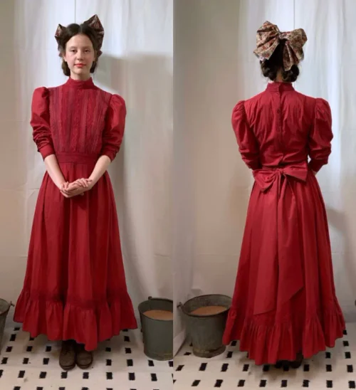 Mia Goth's Costume Fitting Photos for Pearl: Elegant Red Victorian-Inspired Outfit with Ruffles and Bow Accents
