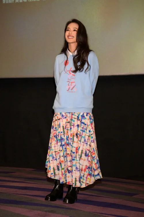 Shu Qi OOTD. Casual Blue Sweatshirt with Colorful Pleated Skirt and Black Ankle Boots