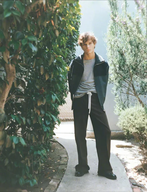 Mason Thames, *Behind the Blinds* photobook. Stylish Neutral Athleisure: Grey Jacket and Drawstring Trousers Ensemble