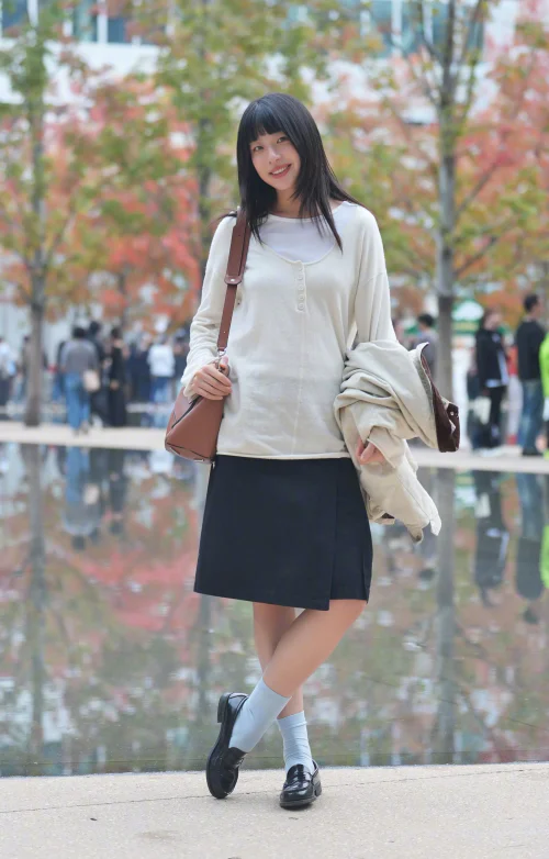 Sweet Girl Street Style. Casual Chic with Cream Top, A-Line Skirt, and Classic Loafers