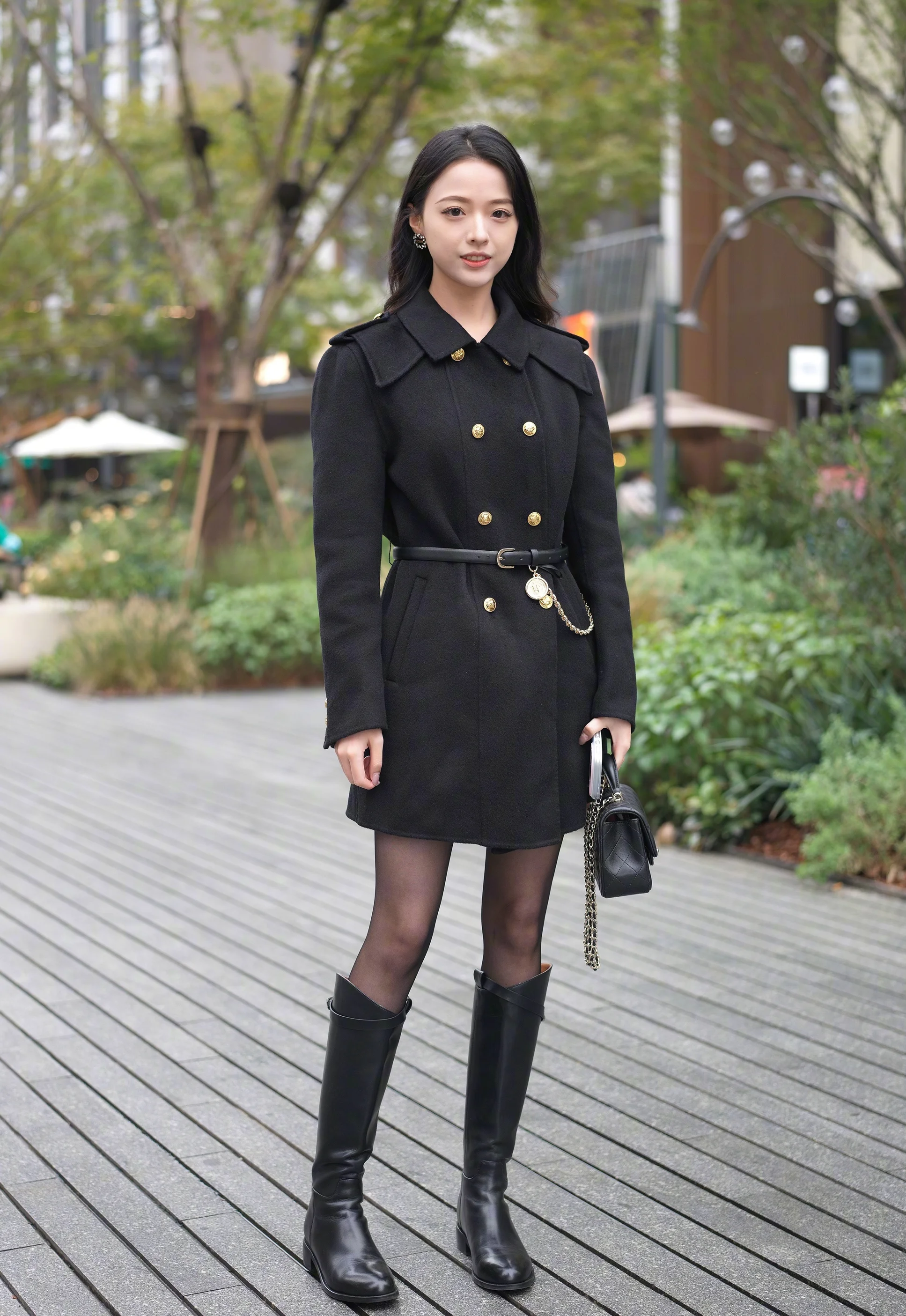Street Style: Elegant Black Coat Dress with Knee-High Leather Boots and Gold Accents