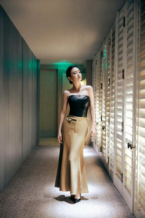 Sleek Black Leather Corset Paired with Luxurious Long Beige Skirt