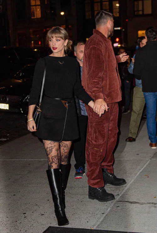 Taylor Swift OOTD. Chic Monochrome Ensemble with Lace Tights and Knee-High Boots for a Sophisticated Evening Look