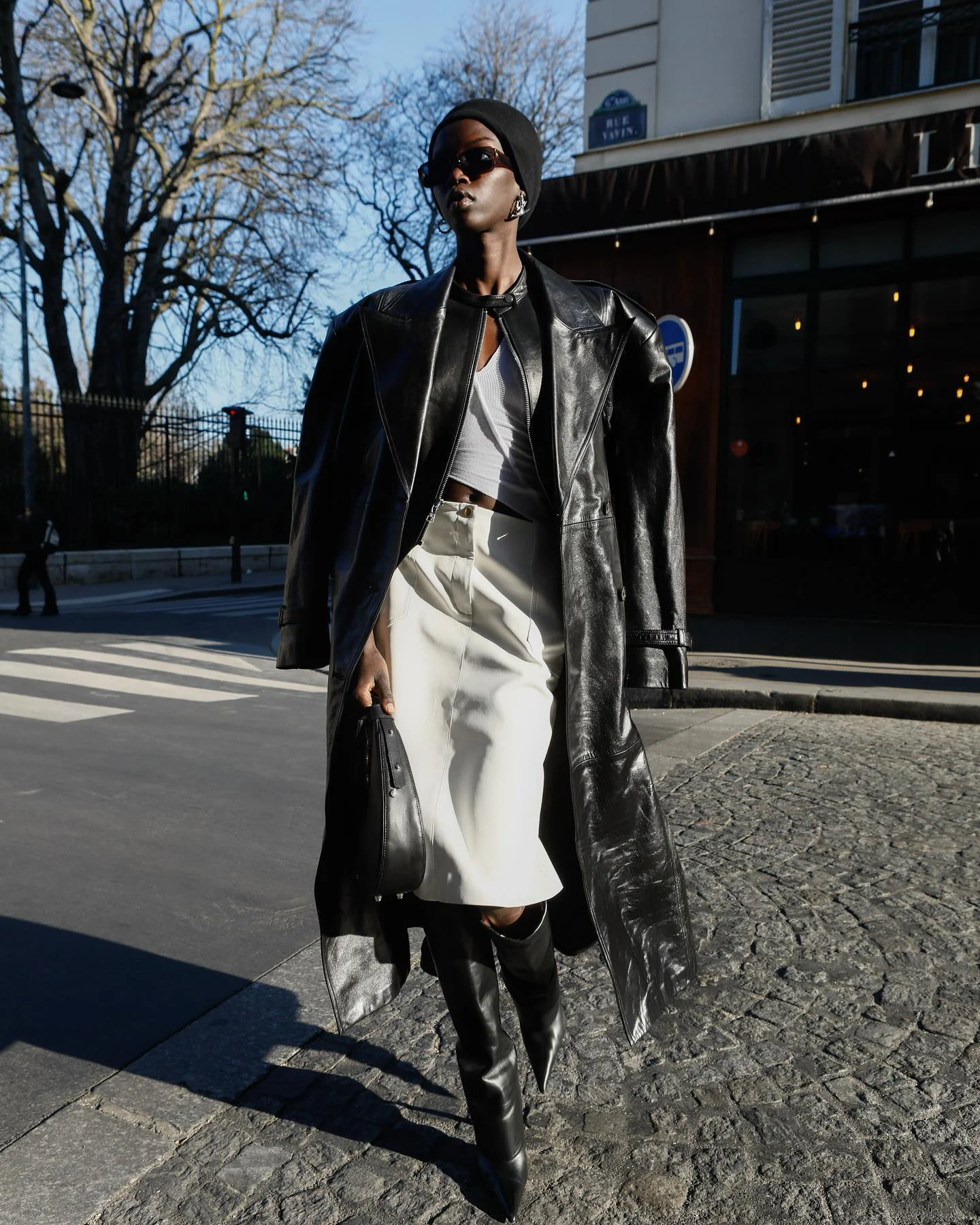Anokyai's Modern Elegance: Black Leather Coat with White Skirt and Tall Boots