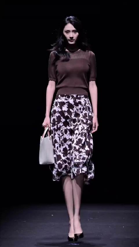 A beautiful model in sheer top & floral midi skirt.